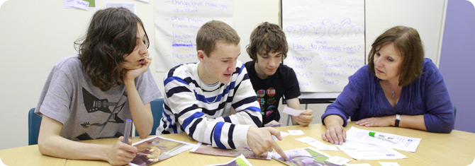 YOT worker demonstrating activities with young people (posed by models) Youngsters participating in a workshop
