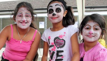 girls at a fundraising event wearing colourful face paints