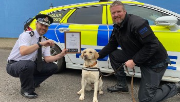 two policemen with police dog in front of police car © RSPCA