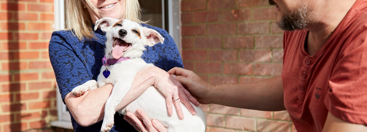happy dog with owners