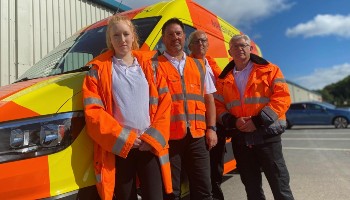 four Animal Search UK staff standing in front of branded van © RSPCA