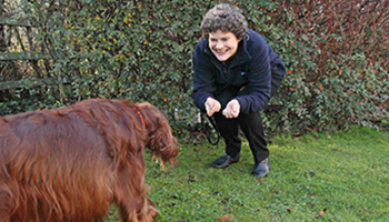Irish red setter and owner outside