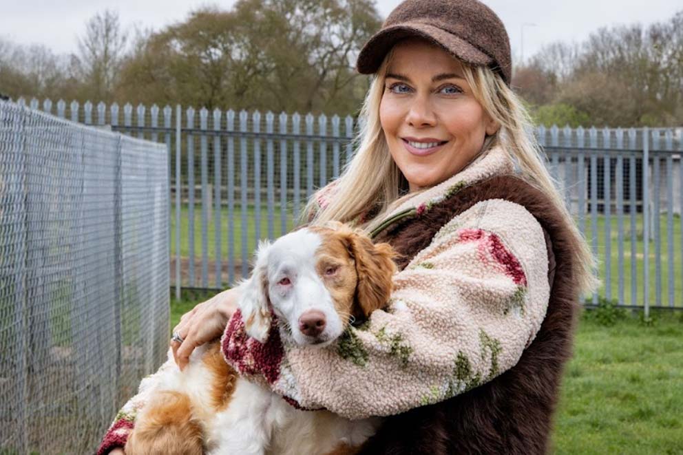TV star, radio DJ and RSPCA Ambassador Kate Lawler holding a rescue dog in her arms