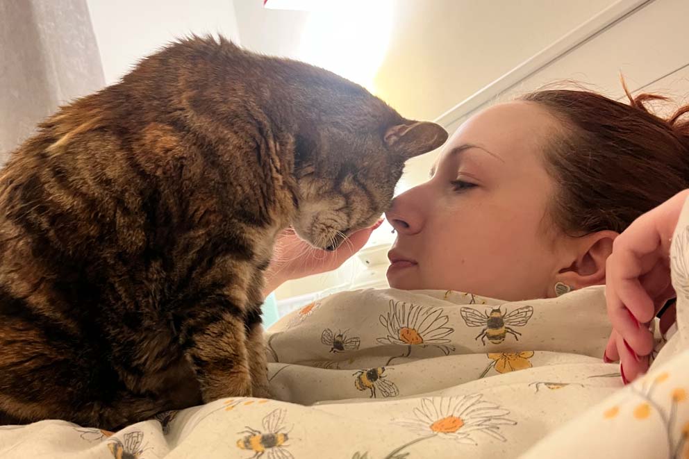 Ella and pet cat Sophie enjoying some nose-to-nose time.