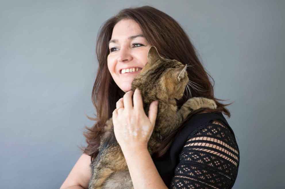 Our CEO, Jo Rowland, holding her tabby cat