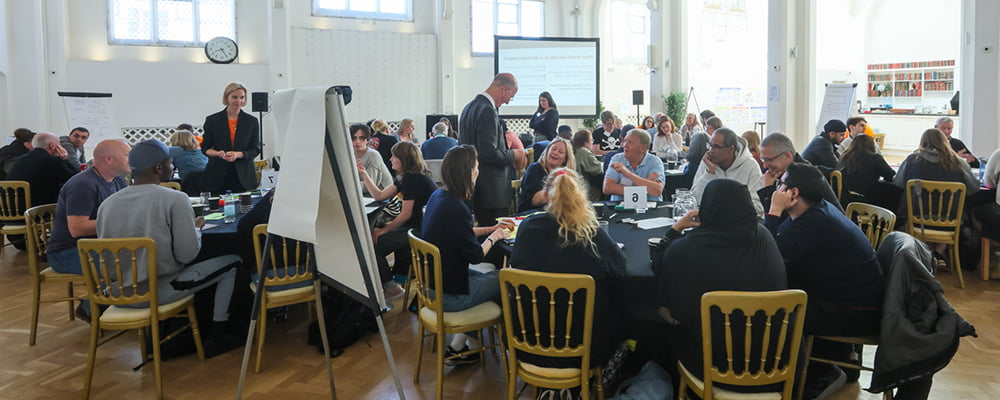A collection of citizens sat around a table debating a topic