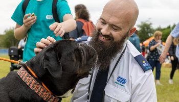 animal rescue officer greeting a dog at an event