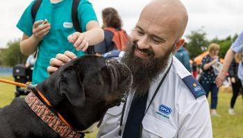 animal rescue officer greeting a dog at an event