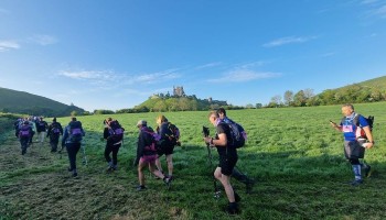 hikers at the start of the Jurassic Coast challenge close to Corfe castle