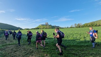 hikers at the start of the Jurassic Coast challenge close to Corfe castle