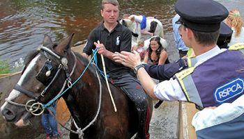 RSPCA inspector approaching horse rider at Appleby Horse Fair