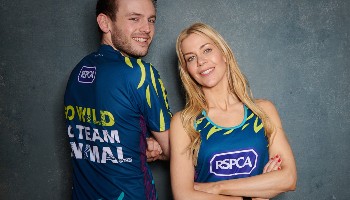 man and woman standing together wearing running vests