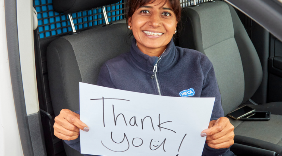 RSPCA Inspector holding a thank you sign