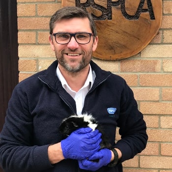 RSPCA inspector Simon Hoggett with guinea pig © RSPCA