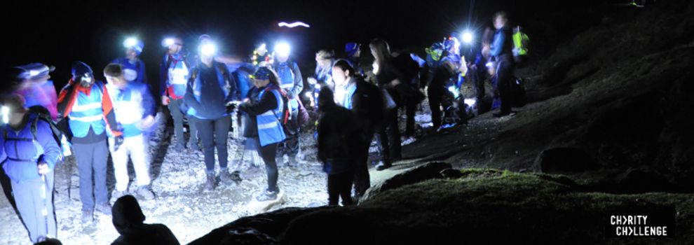 group of hikers wearing headtorches at night