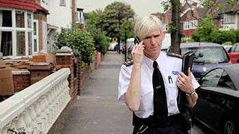 rspca inspector speaking on mobile phone while walking down the street