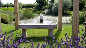 landscaped garden with bench overlooking pond © RSPCA