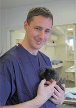Vet surgeon Seb Prior with guinea pig © Joe Murphy/RSPCA photolibrary