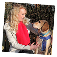 Young woman with a labrador looking at each other