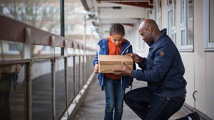 Lad and dad with bird in a box © RSPCA