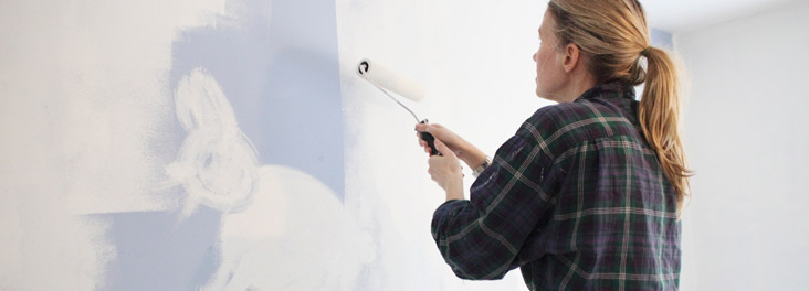 Woman painting wall with rabbit image © RSPCA photolibrary Woman painting wall with rabbit image © RSPCA photolibrary
