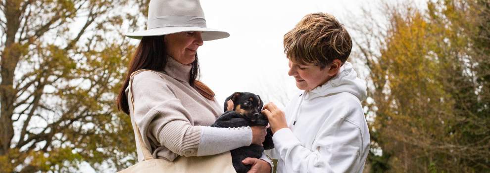 Mother and son holding a puppy